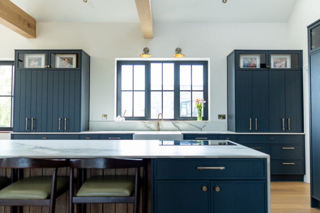 Blue kitchen with white island and sink