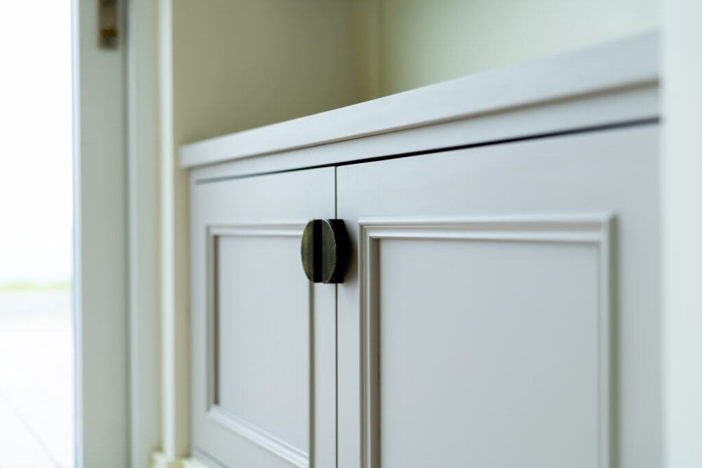 White cabinetry with black handles